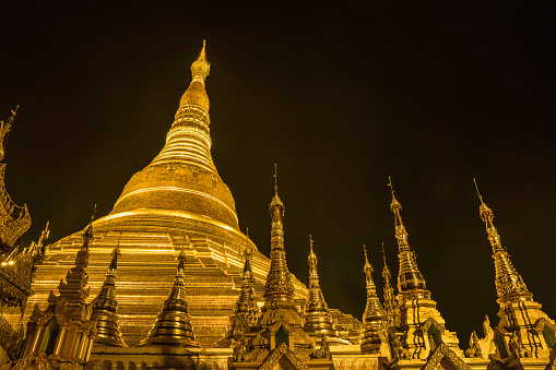 landscape scenery of golden Shwedagon pagoda and small stupa surrounding at night in Yangon Myanmar sacred place and famous tourist attraction