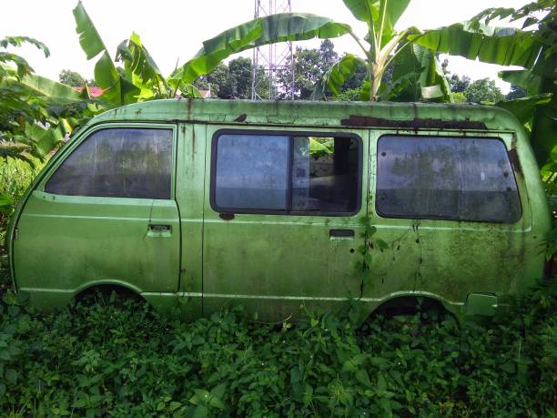 istock A broken and old car was left in the bushes 1442356849