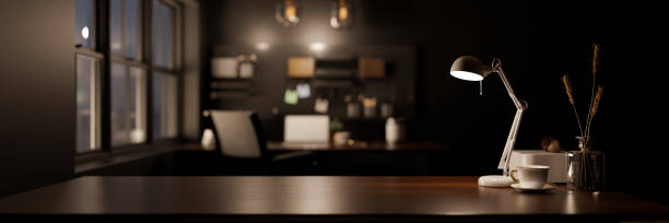 istock Stylish dark workspace tabletop with copy space over blurred modern dark office background 1442363955