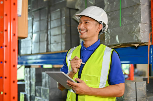 istock Happy Asian foreman or warehouse worker is working in a warehouse, checking inventory 1442364705