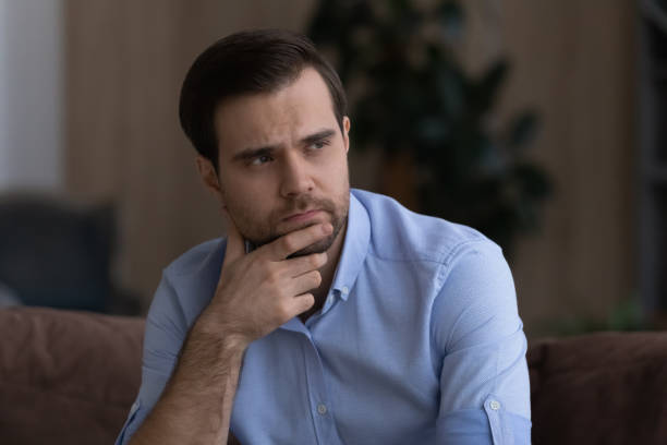 istock Unhappy young businessman rub chin look away think on problems 1442364870