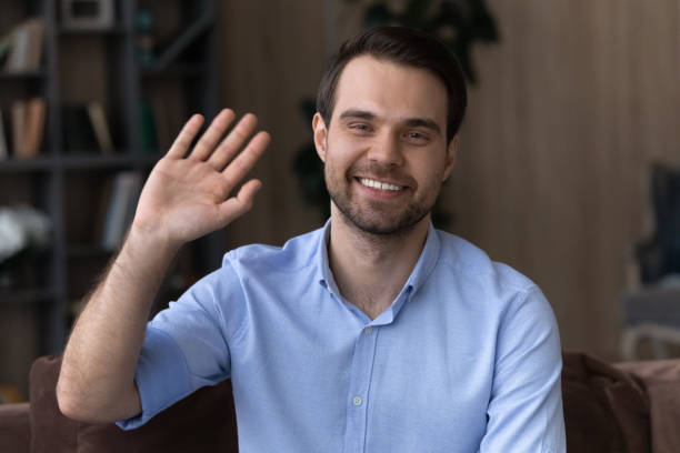 istock Confident young man employee pass webcam job interview wave hand 1442364901