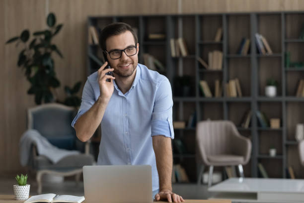istock Positive male employee answer phone call speak about good work 1442364961