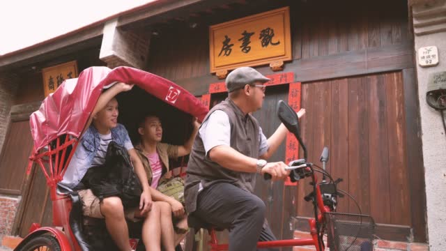 A Local Tour Guide Conducting a Sightseeing Tour with a Tricycle