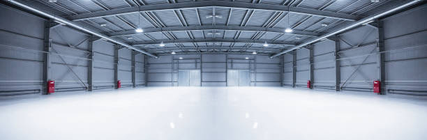 Panorama of empty room of modern storehouse with gates and self-leveling floor stock photo