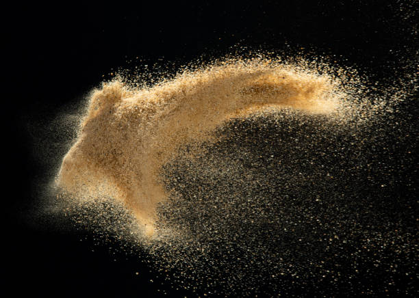 istock Sand flying explosion, Golden sand wave explode. Abstract sands cloud fly. Yellow colored sand splash throwing in Air. Black background Isolated high speed shutter, throwing freeze stop motion 1442367115