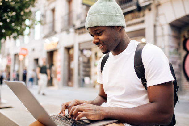 istock Afro man on vacation making a video call on the street 1442371863