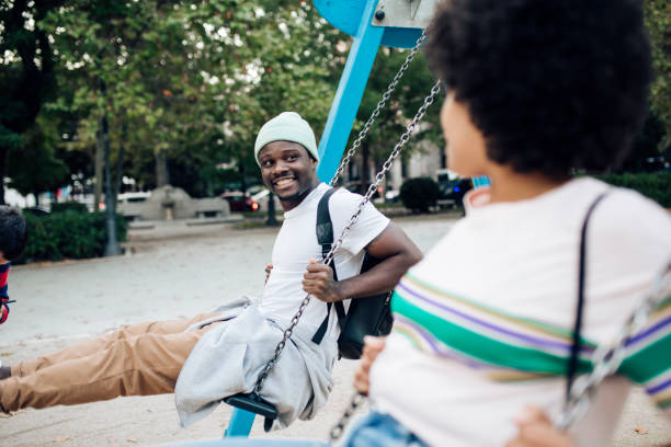 istock Happy couple having fun swinging on a playground. 1442371944