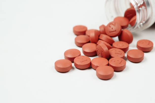 istock red color pain killer spilling form a container on white background 1442374046