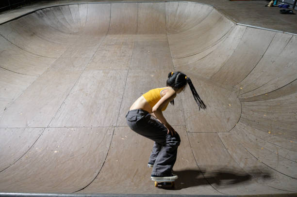 istock Young Woman Skateboarding in Skatepark 1442374514