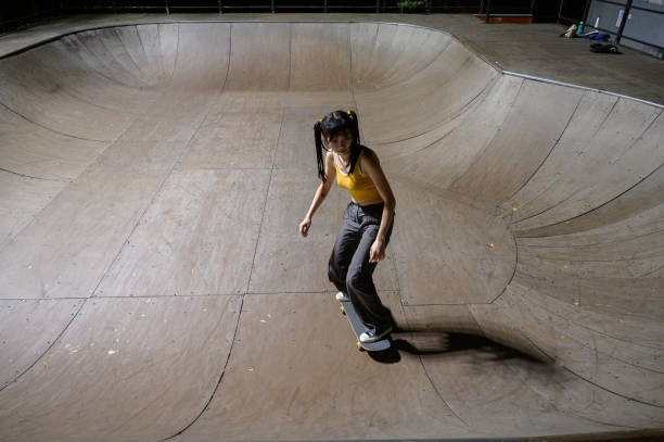 istock Young Woman Skateboarding in Skatepark 1442374518