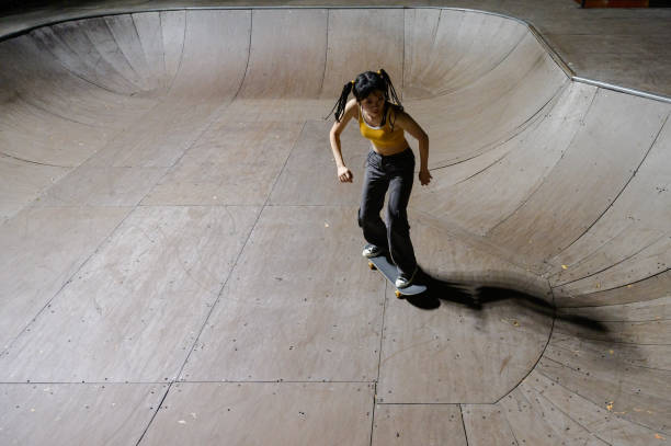 istock Young Woman Skateboarding in Skatepark 1442374853