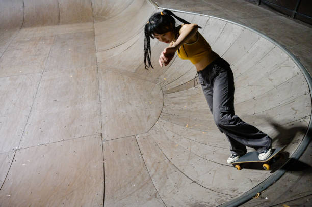 istock Young Woman Skateboarding in Skatepark 1442374879