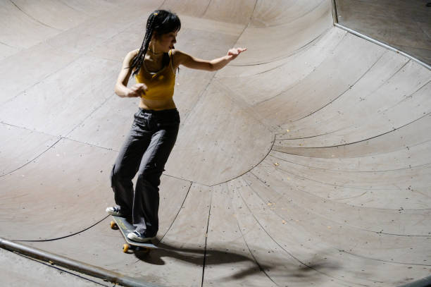 istock Young Woman Skateboarding in Skatepark 1442375663