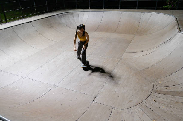 istock Young Woman Skateboarding in Skatepark 1442375752