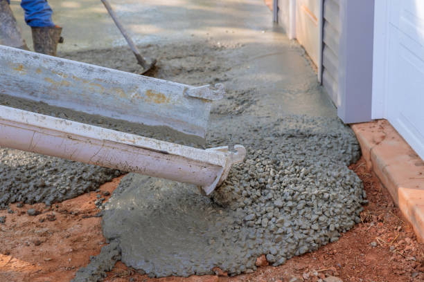 istock While paving a driveway, concrete construction contractors are pouring wet concrete while pouring wet concrete 1442378765