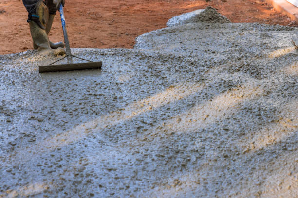 istock Concrete is being poured when it is still wet, on a construction site, as the concrete is being paved for a driveway for a new home. 1442378768
