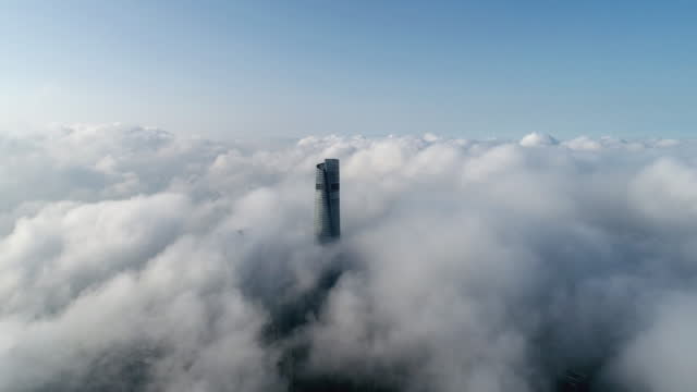4K - Real Time: Drone View of Shanghai Skyscraper on Thick Cloud, China