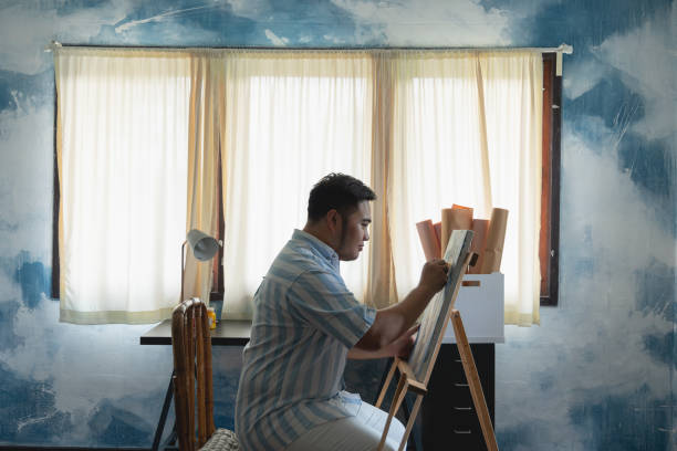 istock Young artist man creating or drawing front of canvas 1442383569