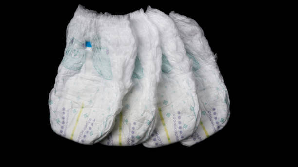 istock Baby diapers stacked each other on isolated background. 1442383673