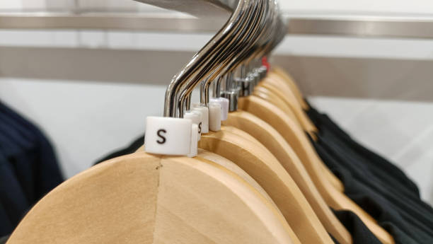istock Close up view of hanging clothes arranged on a display rack small size. 1442383732