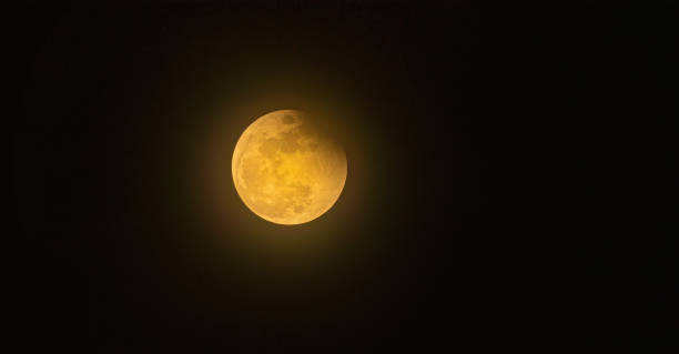 istock Real full blood moon, half moon in black sky with cloud 1442384046