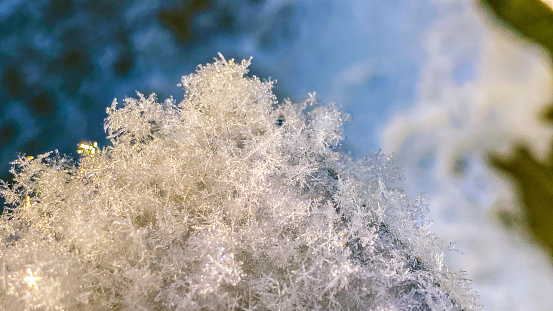 Snow flakes show their fragility as they gently fall and stack upon each other. Some of the flakes manage to hold together and show off their crystal formations.