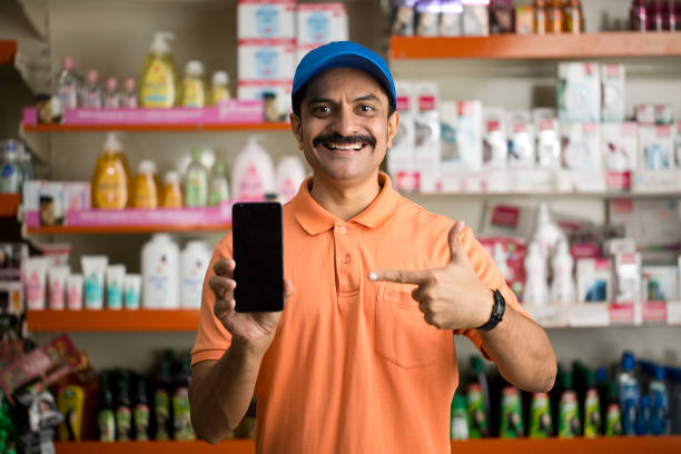 istock Male owner showing phone in store 1442397107