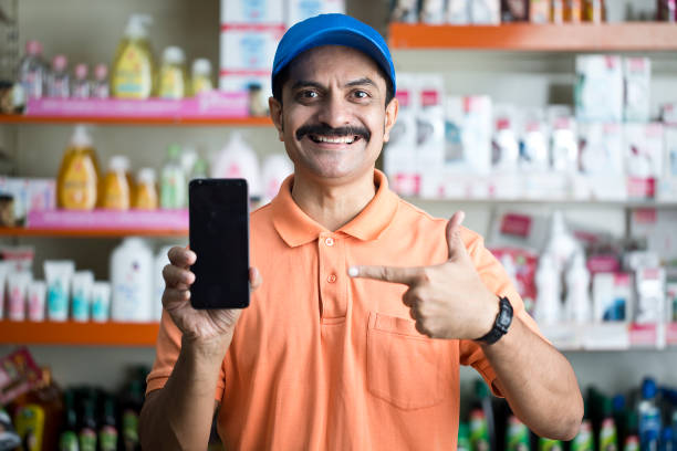 istock Male owner showing phone in store 1442397122