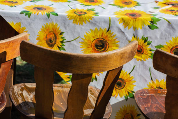istock Closeup of the white tablecloth with a sunflower pattern. 1442403823