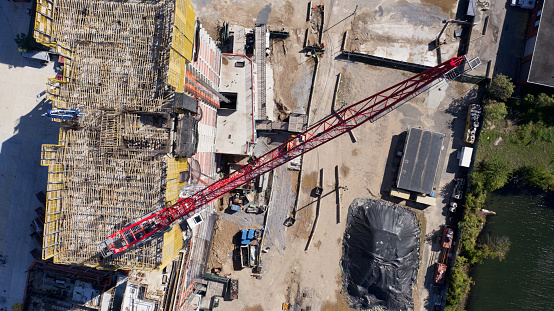 An aerial view of a construction site on the edge of the East River in Brooklyn, New York on a sunny day.