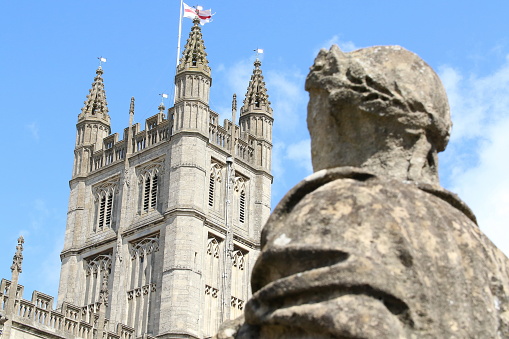 A back view of a Roman soldier statue overlooking The Roman Baths, Anglican Communion, London