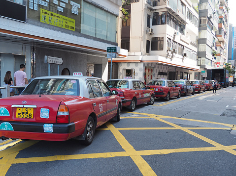 Hong Kong, Hong Kong – October 01, 2019: A row of taxi cars in Hong Kong, China
