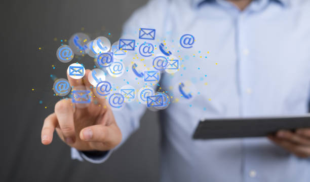 istock Male's hand pointing to phone and email icons 1442405955