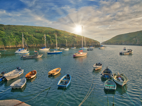 The sun setting on Solva Harbour in Pembroleshire, Wales