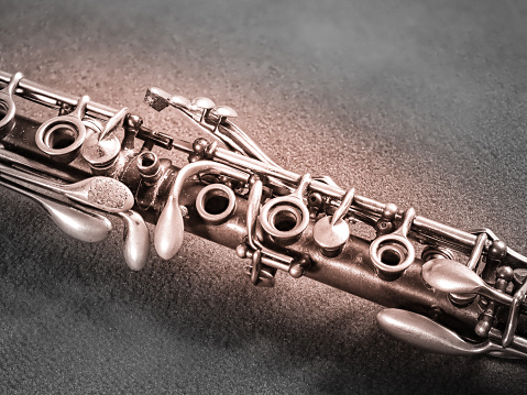 close up of saxophone Player hands  playing alto sax musical instrument over the piano  background,  closeup with copy space, vintage tone,  can be used for music background