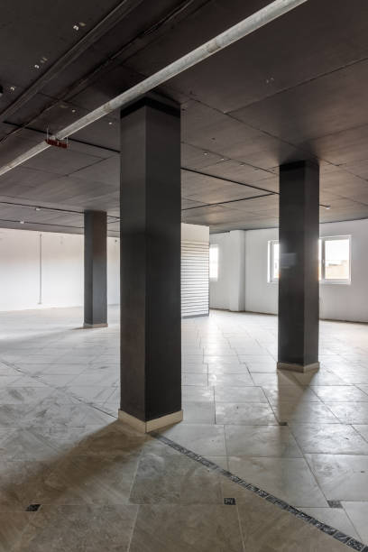 istock Empty retail space with a black ceiling and a dirty floor, immediately after repair 1442409121