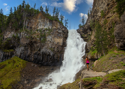 A rear view of a woman hiker resting in Yellowstone National Park, USA