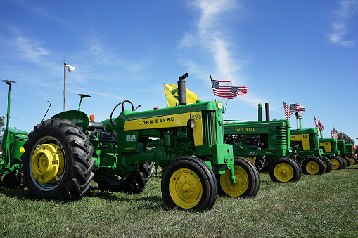 Kansas City, United States – October 11, 2021: The John Deere Vintage Classic Tractor Show with US flags