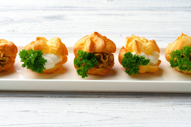 istock Profiteroles stuffed with soft mousse banquet food snacks 1442413169