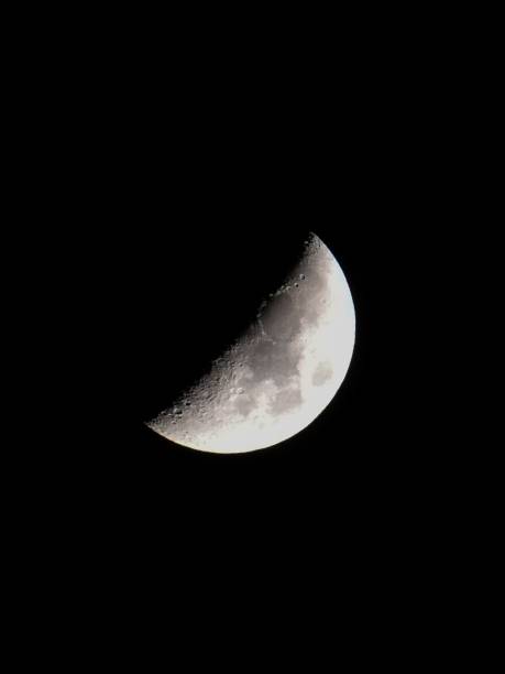 istock Vertical shot of the half moon in the dark night sky 1442413421