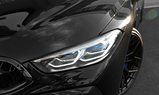 Munich, Germany – October 13, 2021: The headlights of a BMW M8 Competition