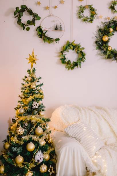 istock Beautiful decorated Christmas tree in the living room next to a sofa 1442415536