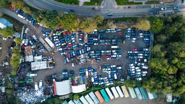 istock High angle of a scrapyard during the day with trees around it. 1442416111