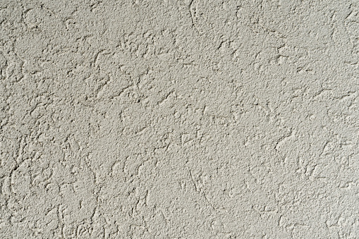 Close-up of a bright yellow roughcast wall.