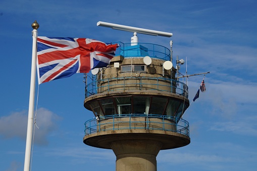 A Union Jack flag against the Calshot Tower