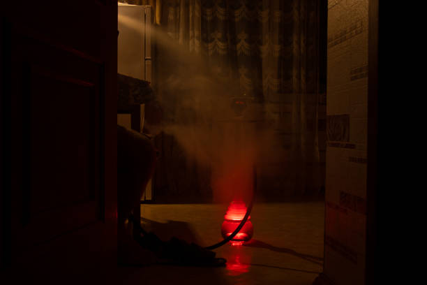 istock A man smokes hookah in the kitchen in the dark during a power outage in Ukraine, we cannot be defeated, rest 2022 1442418945