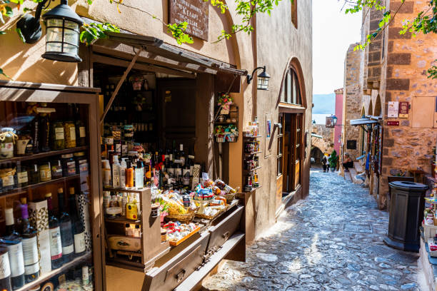 View of a small shop selling wine and souvenirs in Monemvasia, Greece Monemvasia, Greece – October 02, 2021: A view of a small shop selling wine and souvenirs in Monemvasia, Greece monemvasia stock pictures, royalty-free photos & images