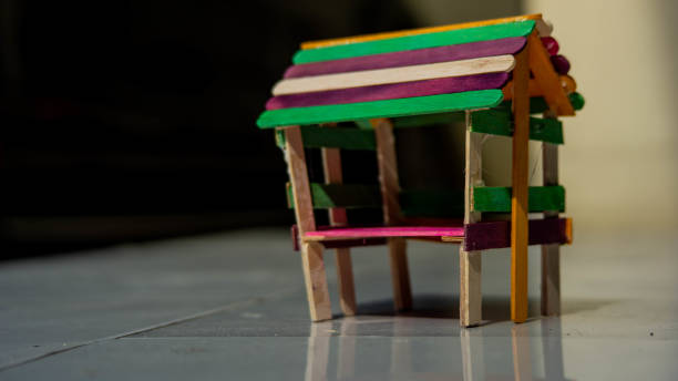 istock Tiny colorful handicraft hut made from used sticks of popsicles. 1442422390
