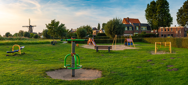 A playground  for kids with green grass in a residential neighborhood in The Netherlands